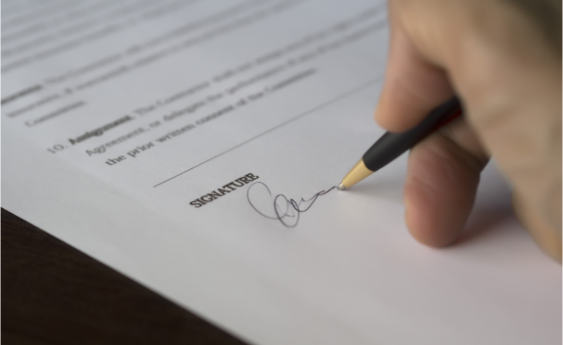 A person signing a document for approval
