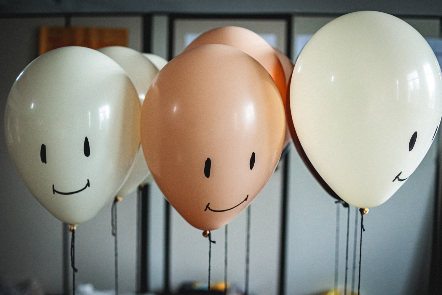 3 balloons with smiling faces