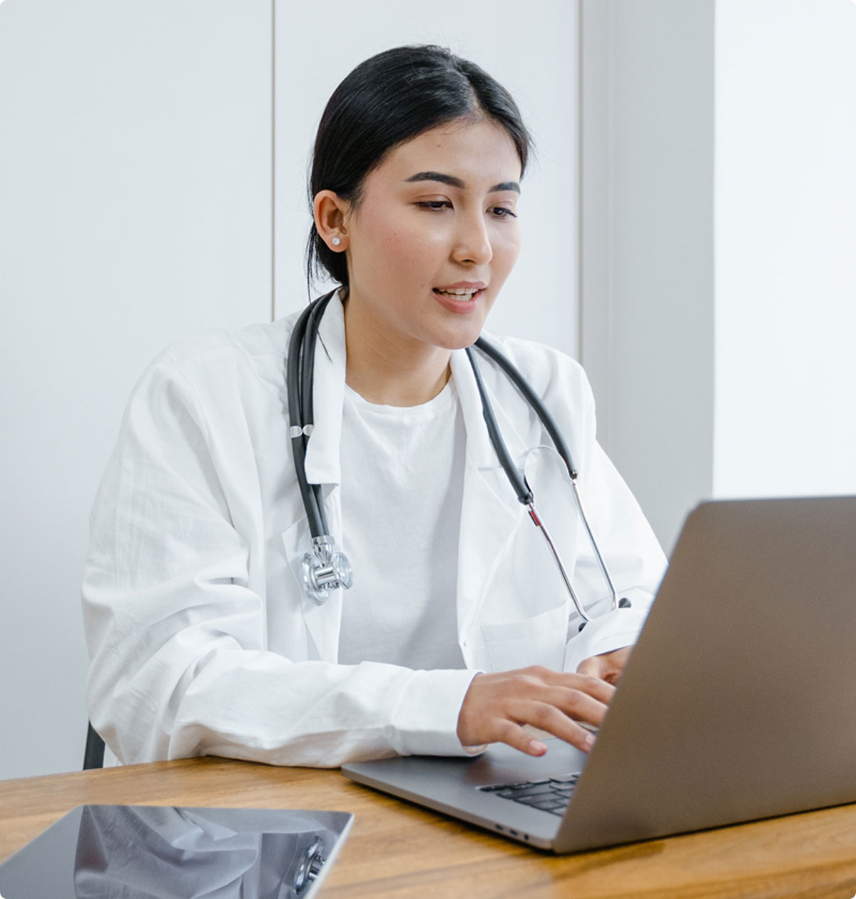 Clinical Leader works on a computer at her desk.