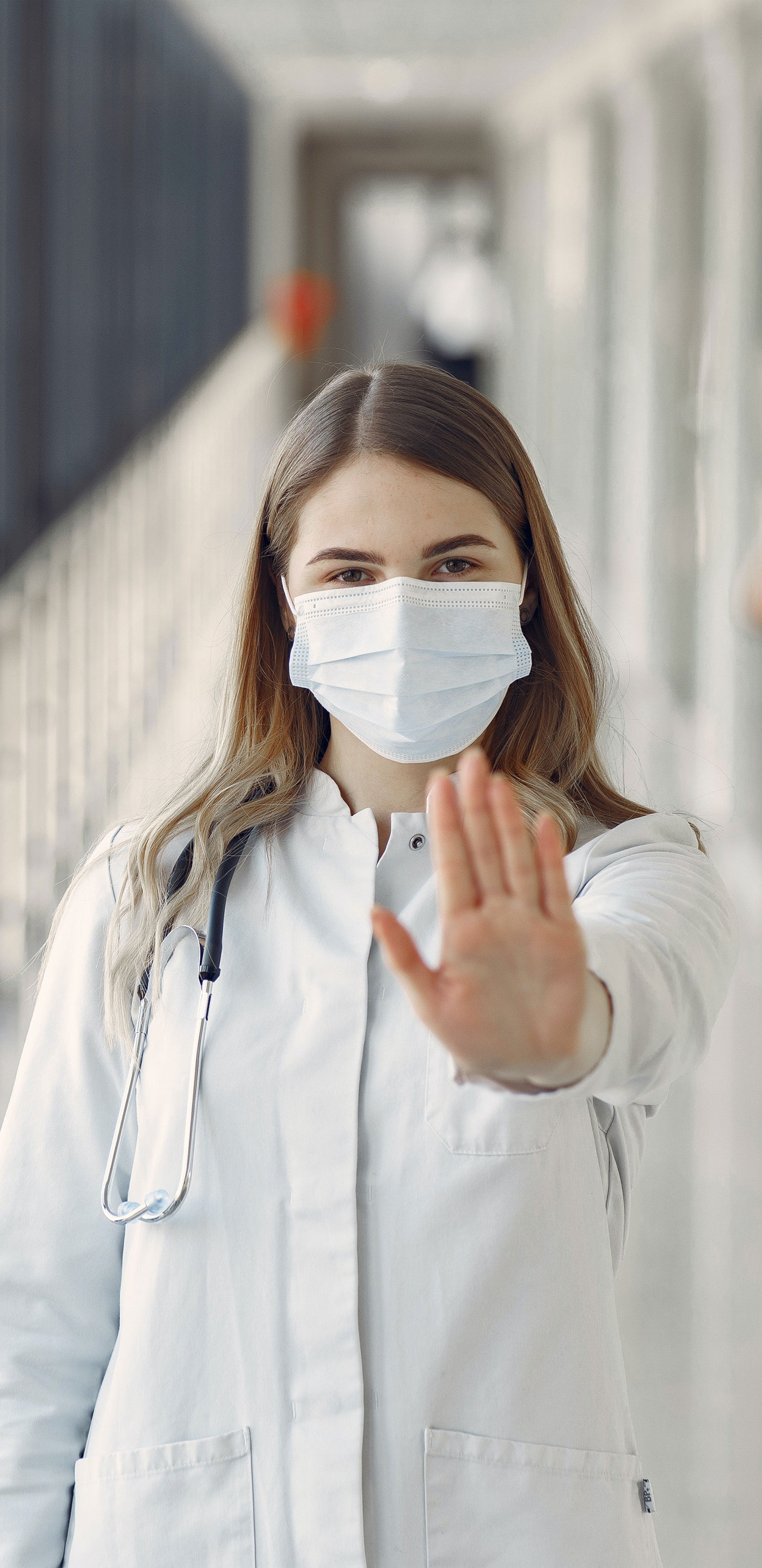 Woman stopping men not wearing proper face mask.